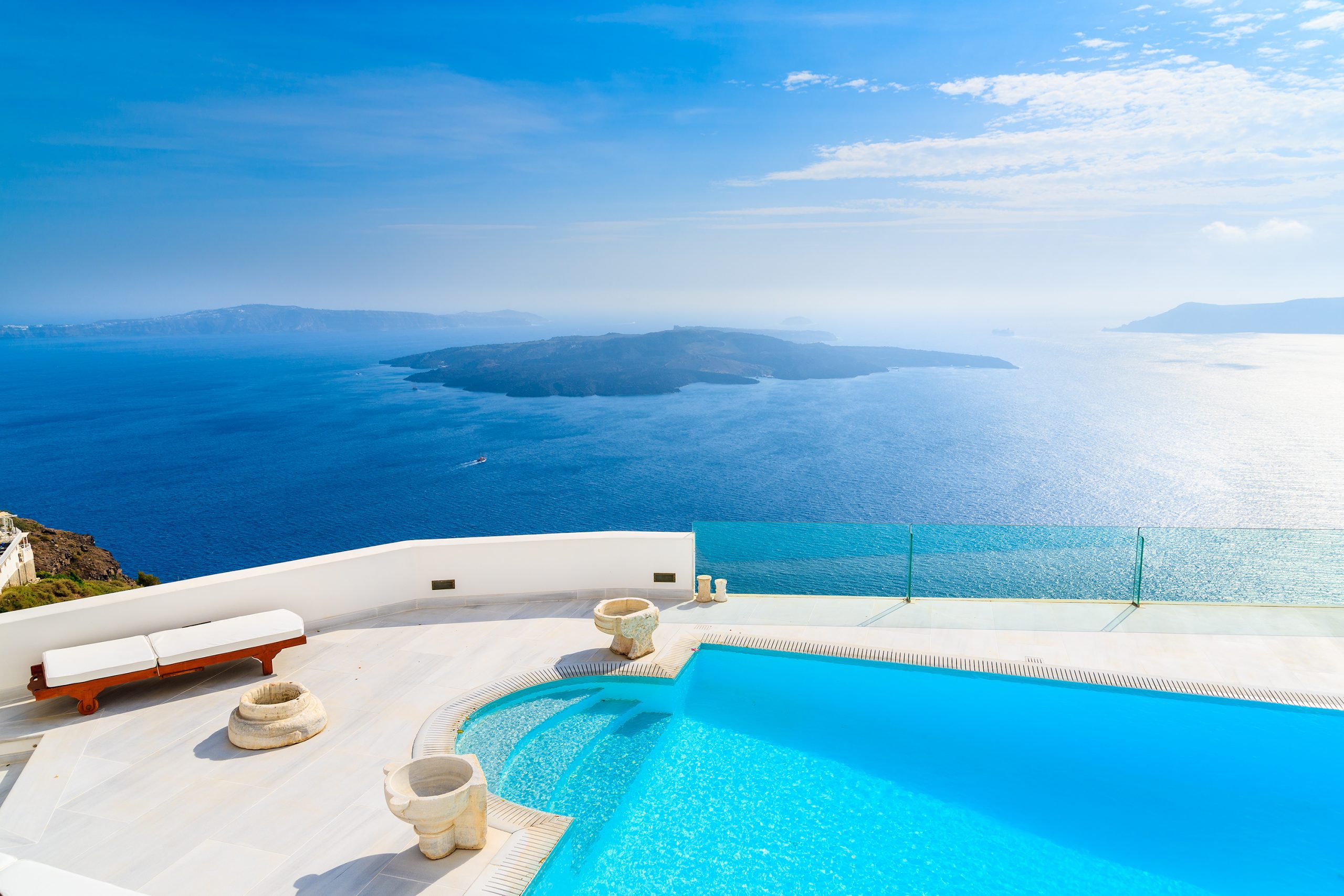 A view of caldera and luxury hotel swimming pool in foreground