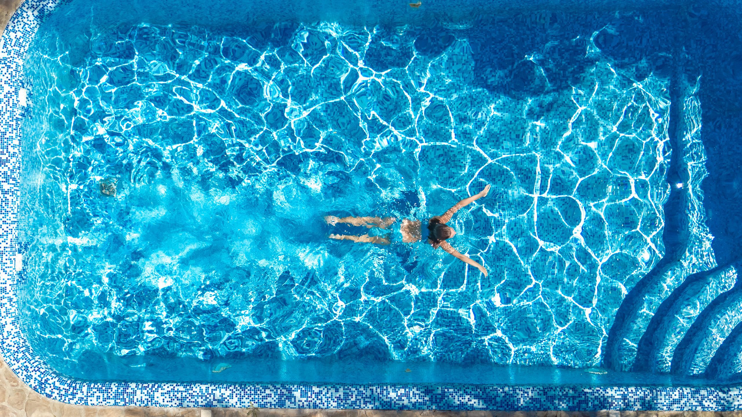 woman swimming alone in the pool